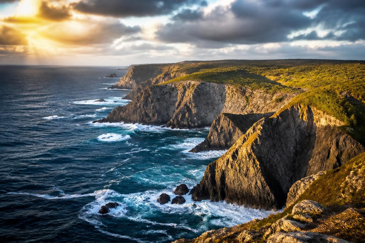 Dramatic cliffs of the Costa Vicentina meeting the Atlantic Ocean at sunset
